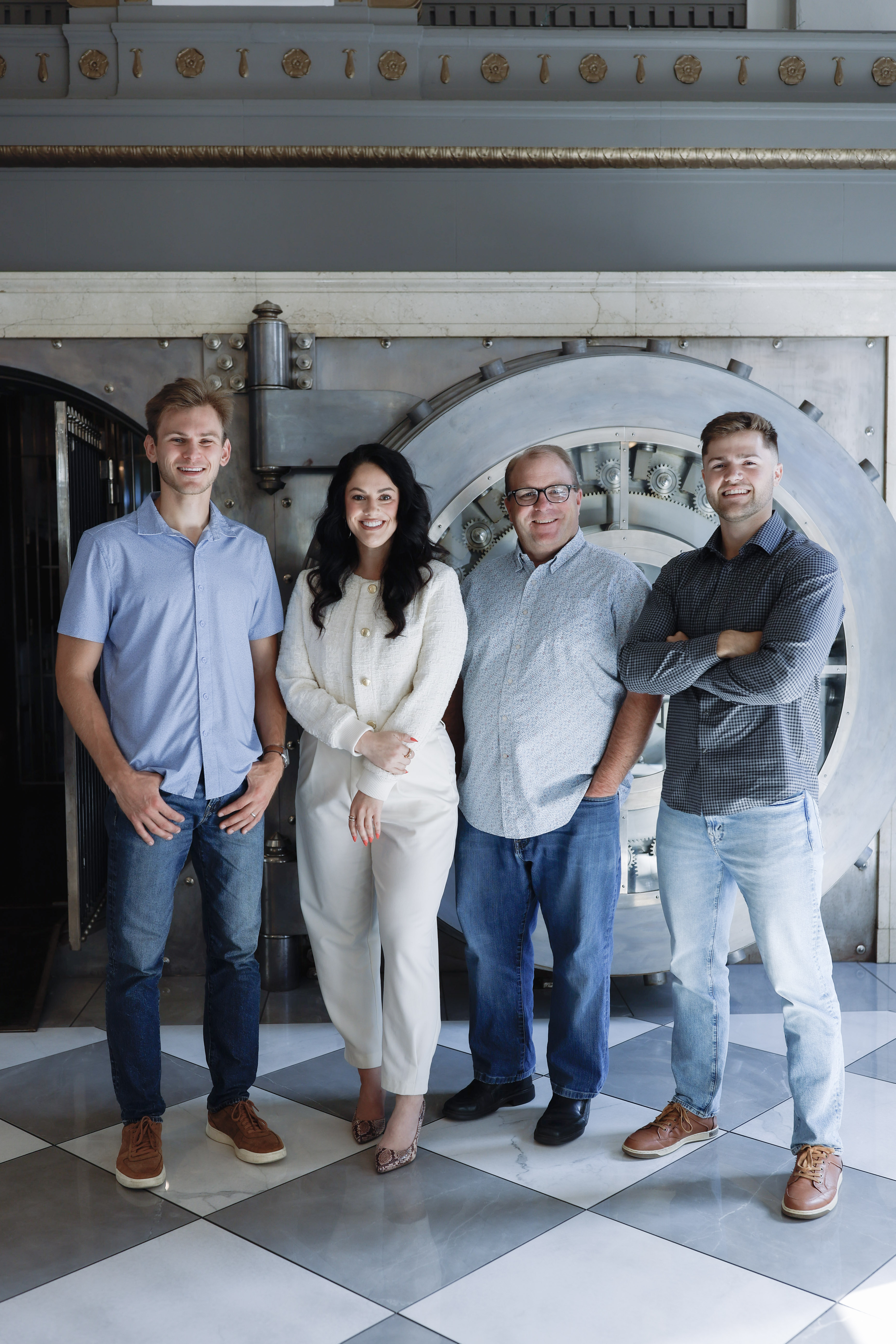 Team posing together in vault setting
